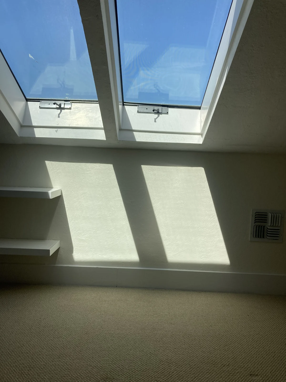 Skylight surround after drywall repair — finished, painted white drywall, clean corners, ready for use